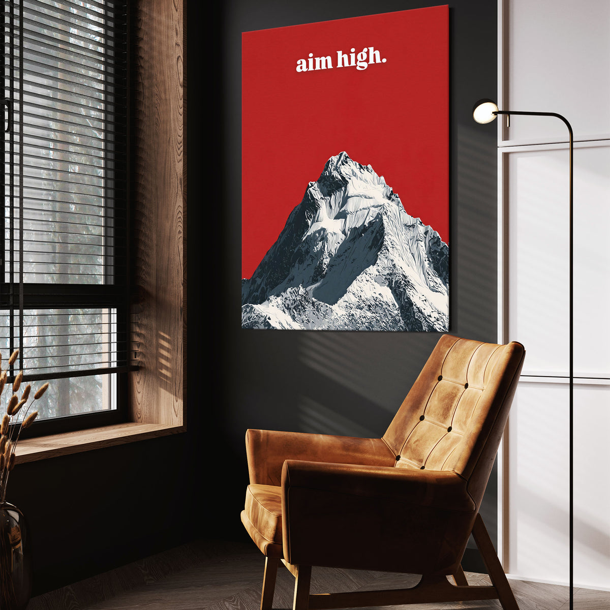 Aim High wall art above a tan chair in a dark reading corner