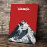 Aim High wall art leaning against a brick wall