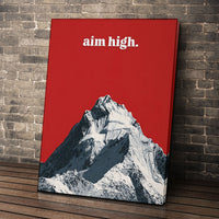Aim High wall art leaning against a brick wall