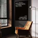 Balance quote wall art above a tan chair in a dark reading corner