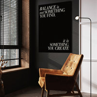 Balance quote wall art above a tan chair in a dark reading corner