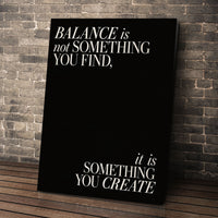 Balance quote wall art leaning against a brick wall