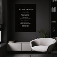 Choose Your Hard wall art above a white chair in a dark room