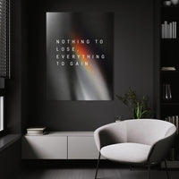 Everything To Gain motivational wall art above a white chair in a dark room