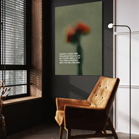 Growth Takes Time wall art above a wooden lounge chair in a dark room