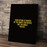 Habits Over Goals wall art leaning against a brick wall