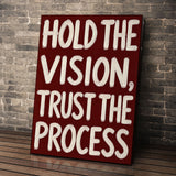 Hold the Vision wall art leaning against a brick wall