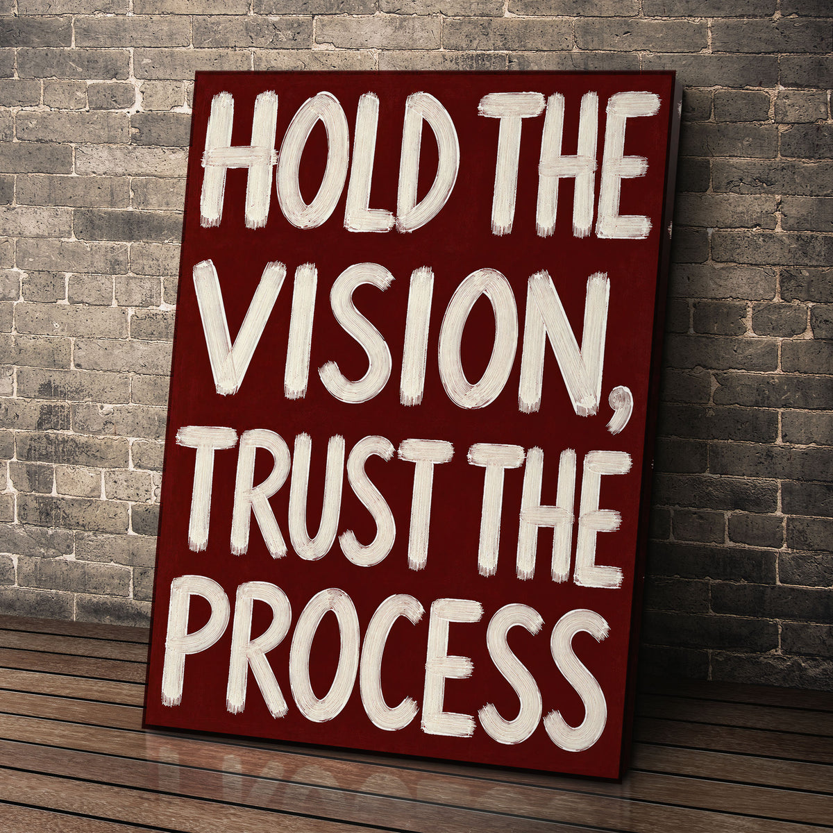 Hold the Vision wall art leaning against a brick wall