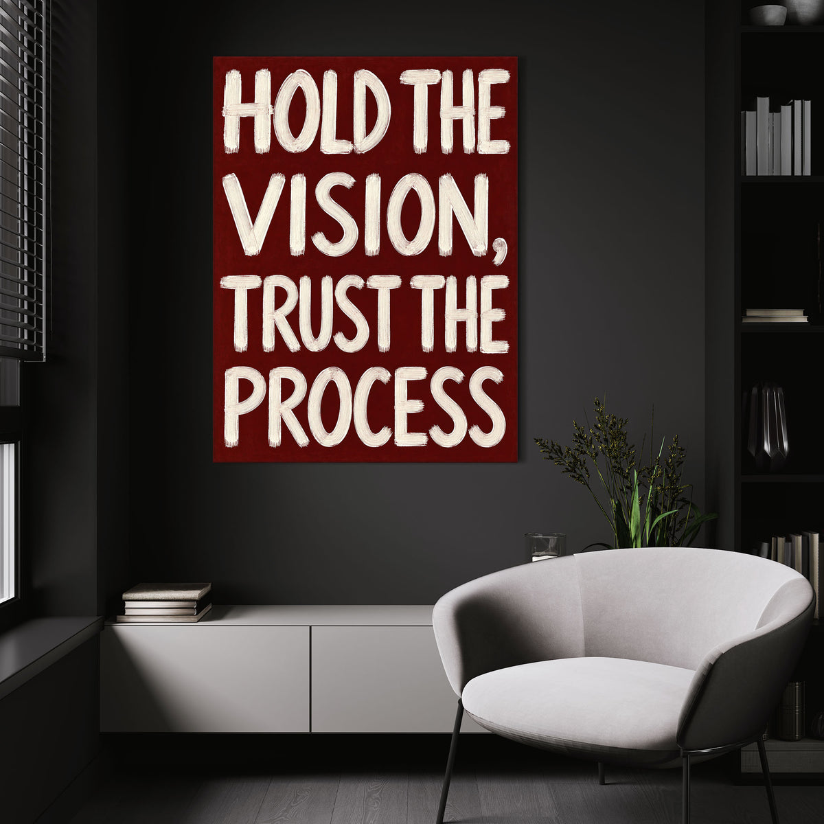 Hold the Vision wall art above a white chair in a dark room