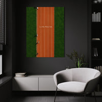 Let The Work Talk wall art above a white chair in a dark room
