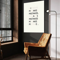 Mistakes wall art above a tan chair in a dark reading corner