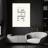 Mistakes wall art above a white chair in a dark room