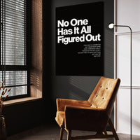 No One Has It All Figured Out wall art above a tan chair in a dark reading corner