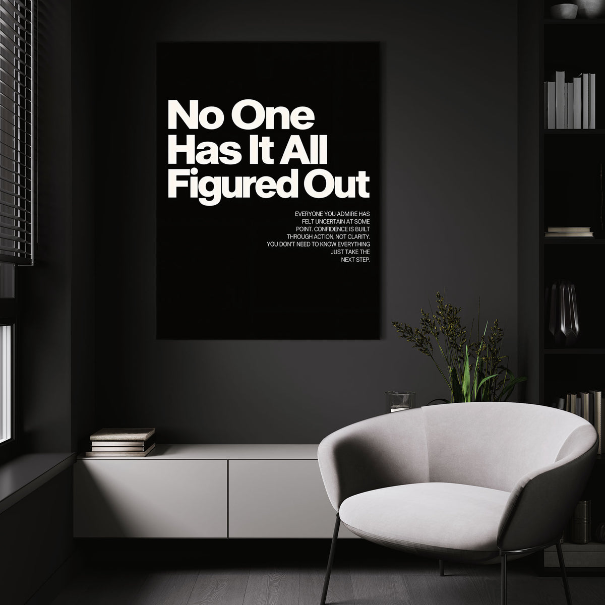No One Has It All Figured Out wall art above a white chair in a dark room