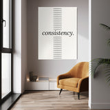 Show Up Daily wall art above a tan chair in a bright room