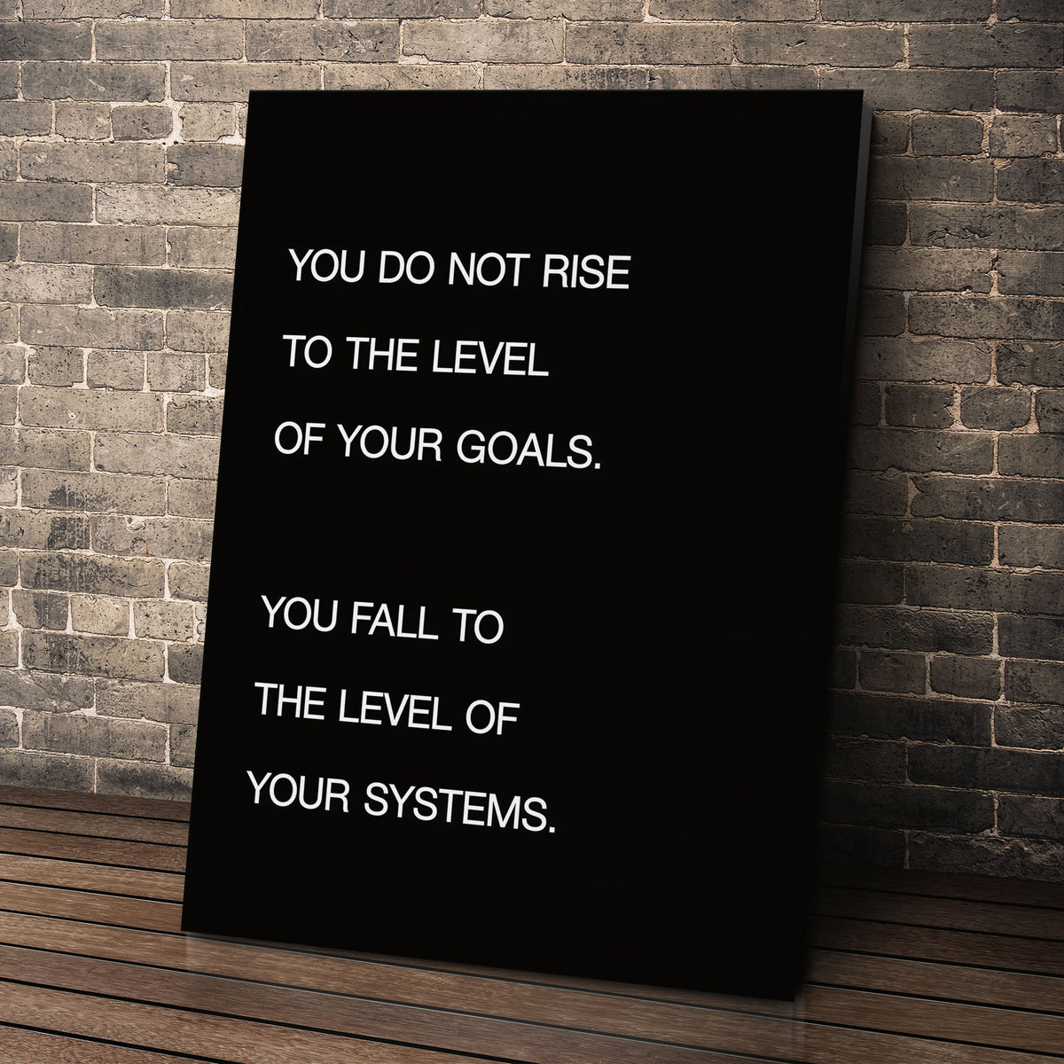 Systems > Goals wall art leaning against a brick wall