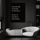 Systems > Goals wall art above a white chair in a dark room