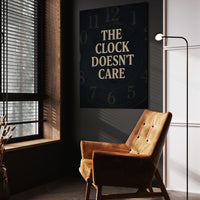 The Clock Doesn't Care wall art above a tan chair in a dark reading corner