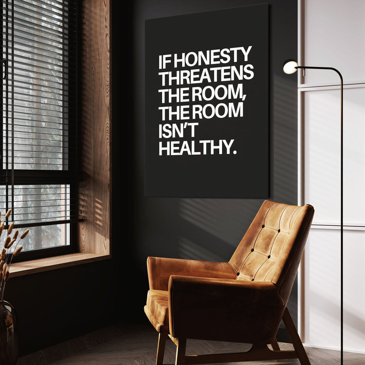 The Room wall art above a tan chair in a dark reading corner