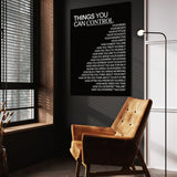 Things You Can Control (Black) wall art above a tan chair in a dark reading corner