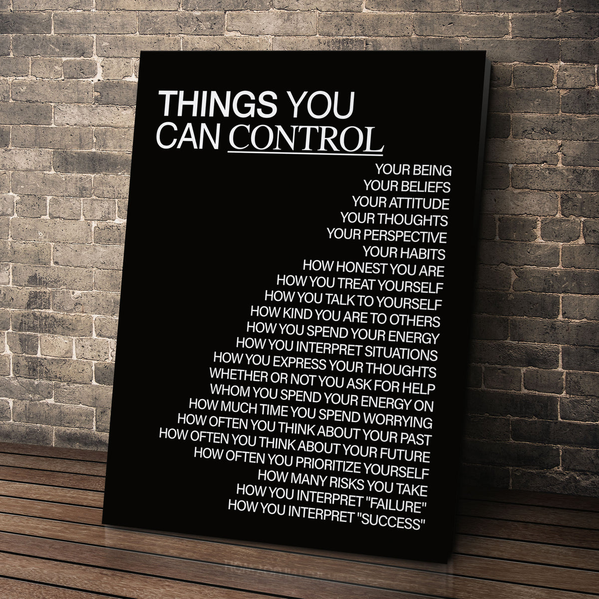 Things You Can Control (Black) wall art leaning against a brick wall