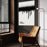 Until It Works wall art above a tan chair in a dark reading corner