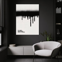 Until It Works wall art above a white chair in a dark room