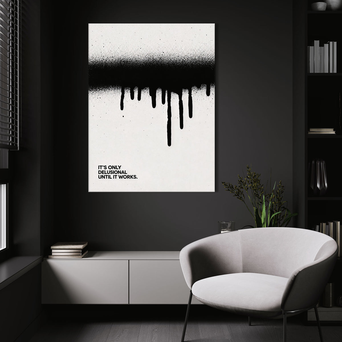 Until It Works wall art above a white chair in a dark room