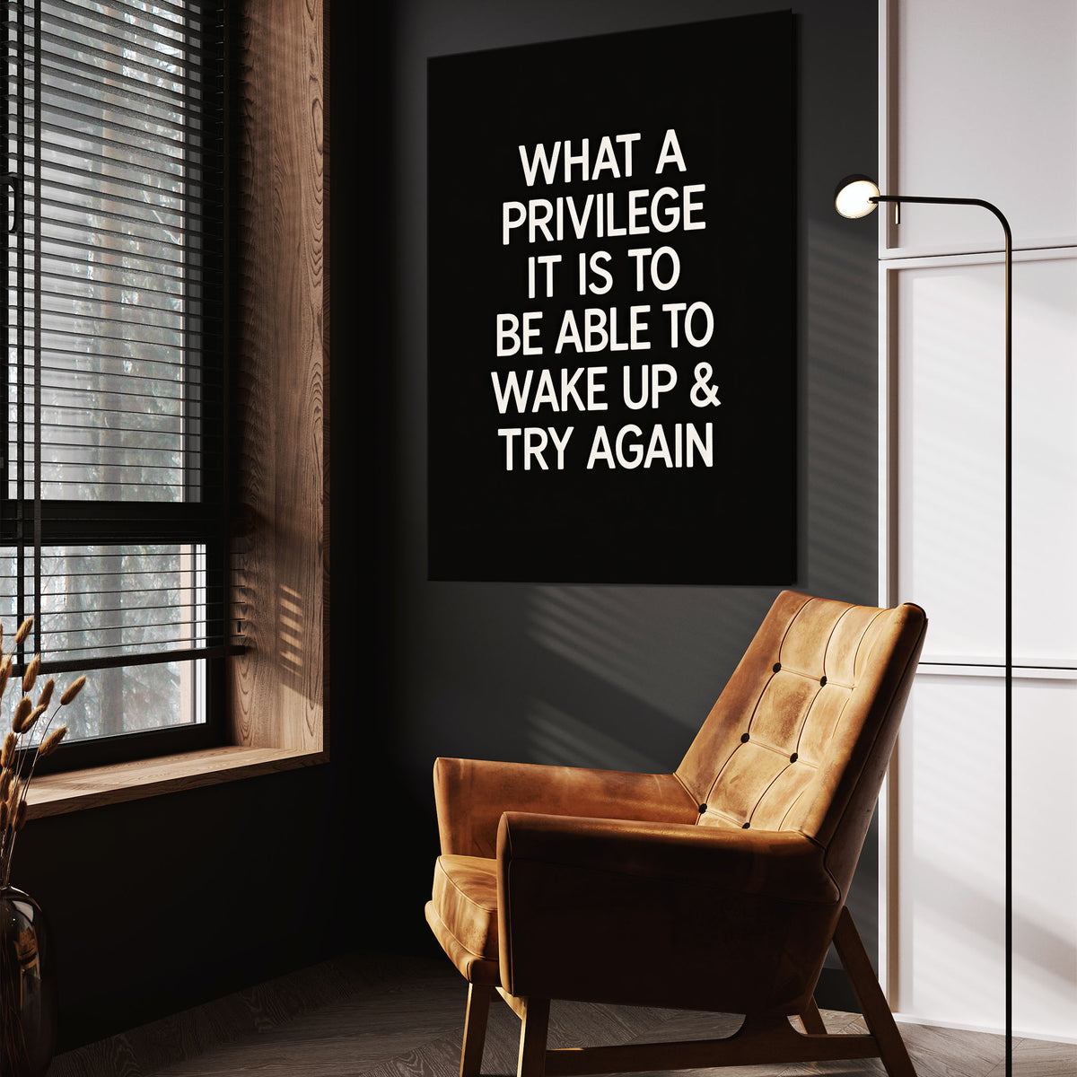 What A Privilege motivational wall art above a tan chair in a dark reading corner