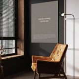 Win The Morning wall art above a wooden lounge chair in a dark room