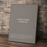 Win The Morning wall art leaning against a brick wall