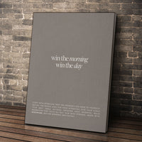 Win The Morning wall art leaning against a brick wall