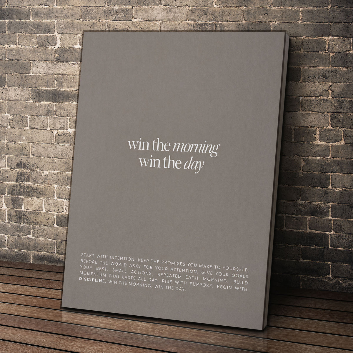 Win The Morning wall art leaning against a brick wall