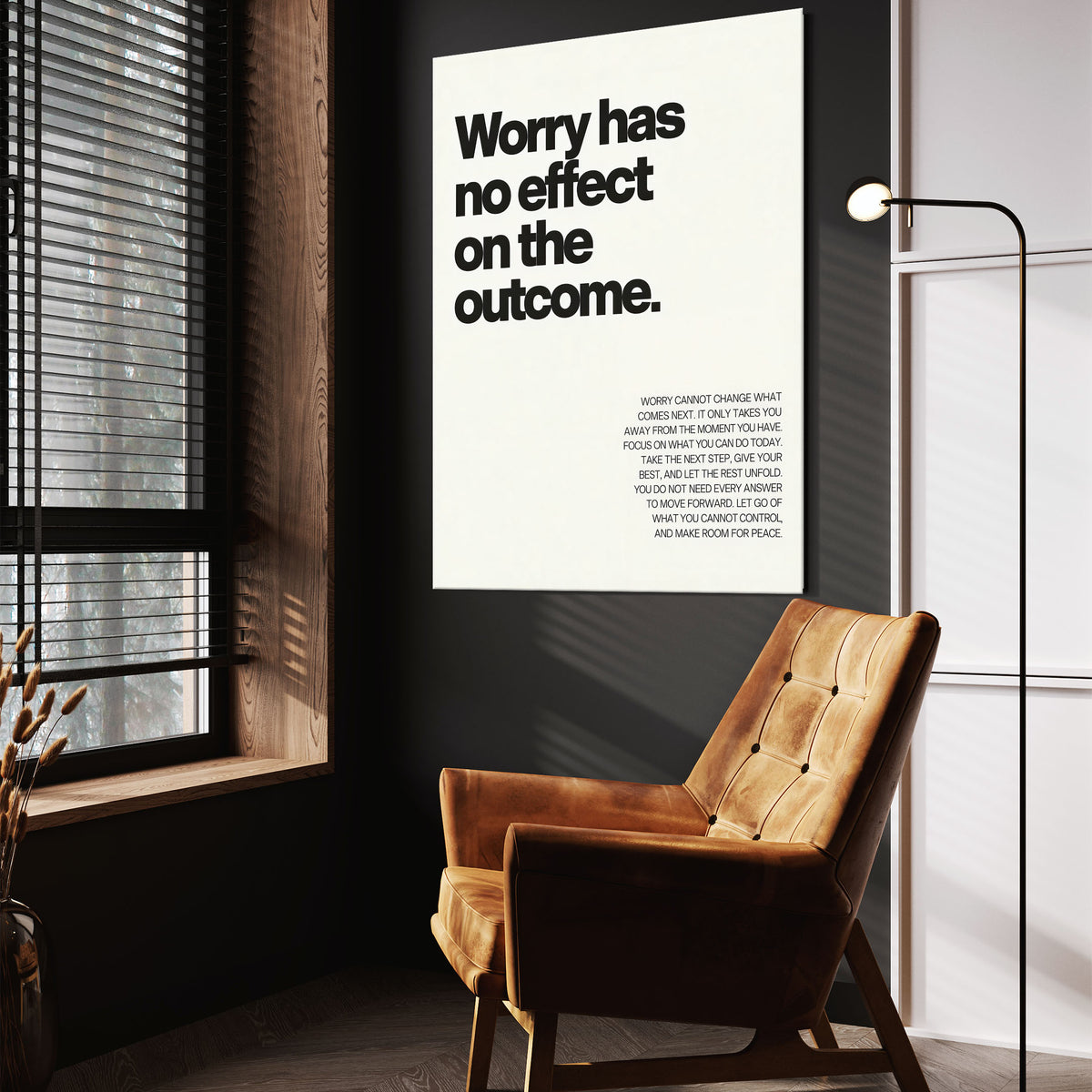 Worry Has No Effect wall art above a tan chair in a dark reading corner